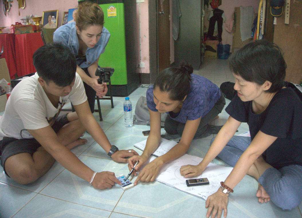 Illustration of a design research session with people around a table and a magnifying glass